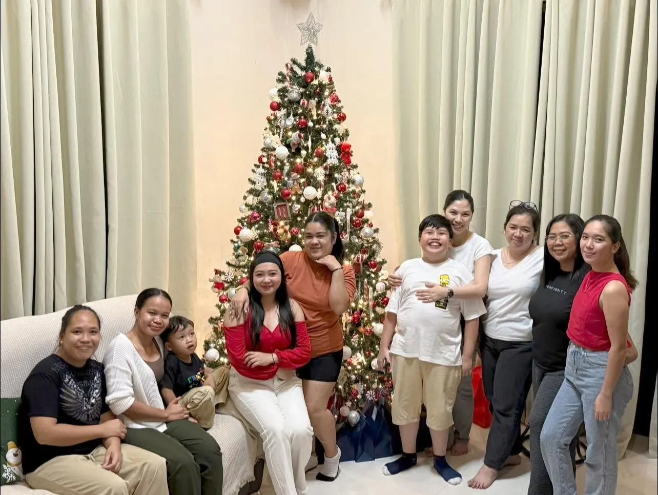 The SkinCentrum team together by the clinic Christmas tree